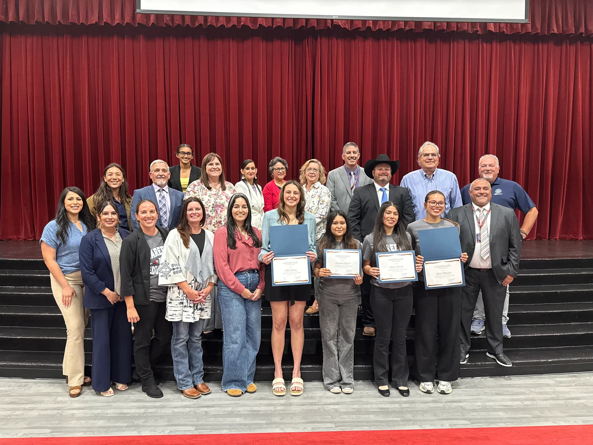 Students holding certificates with Fresno County educators and community leaders