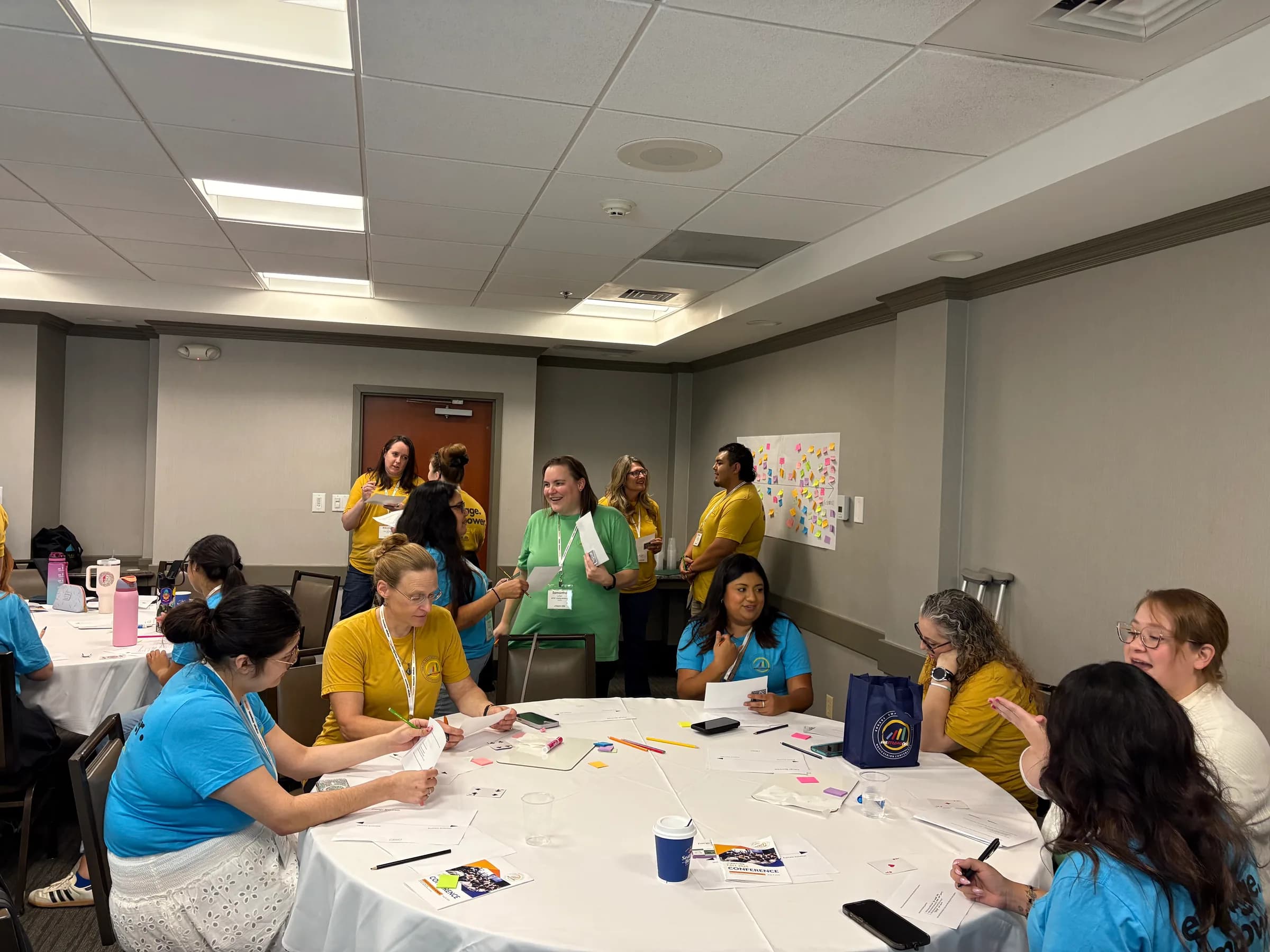 Learn4Life educators collaborating around workshop tables